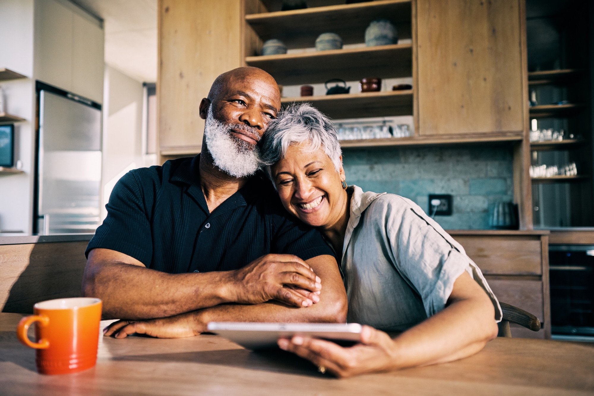Couple sharing a laugh at the kitchen counter